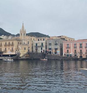 a group of boats in a body of water with buildings