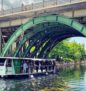 a boat on a river under a bridge