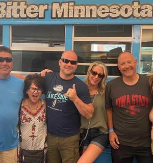 a group of people standing in front of a bus