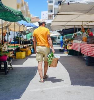 a man walking through an outdoor market