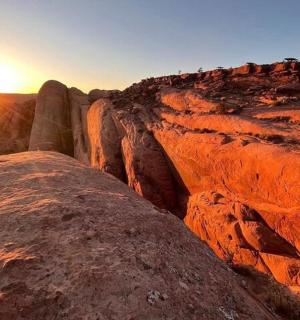a view of a canyon with the sun setting on the horizon