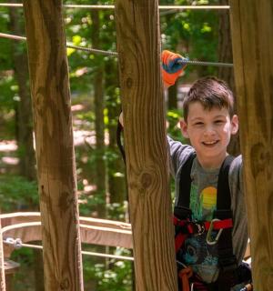 a young boy is playing on a roller coaster