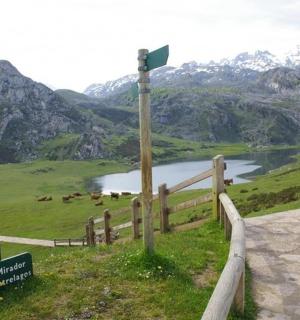 a sign on the side of a mountain with a lake