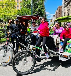 a group of people riding in a bike pulled cart