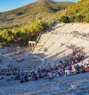 a large crowd of people sitting in an amphitheater