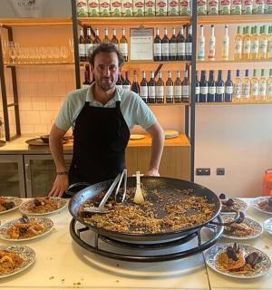 a man standing in front of a table of food