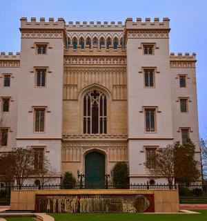 a large white building with a fence in front of it