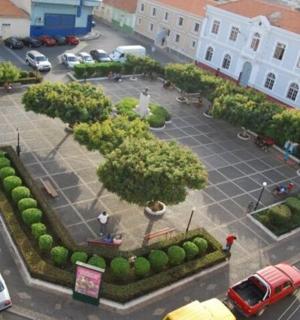 an aerial view of a parking lot with cars and trees