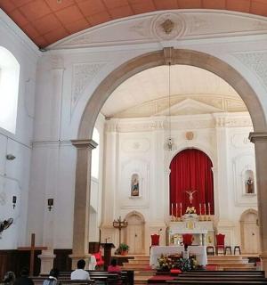 a large church with a red organ in it