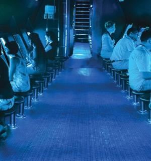 a group of people sitting on seats in a train