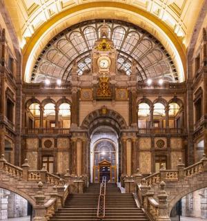a large building with stairs and a clock on the ceiling