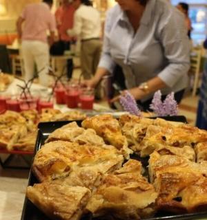 a woman standing in front of a table with pizza