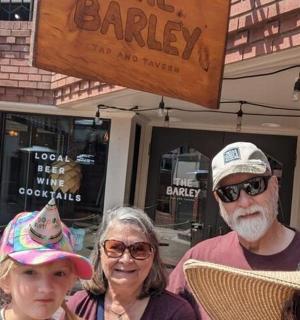 a group of people standing in front of a bakery