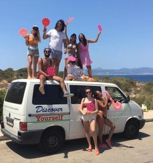 a group of people sitting on the back of a van