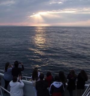a group of people on a boat in the ocean