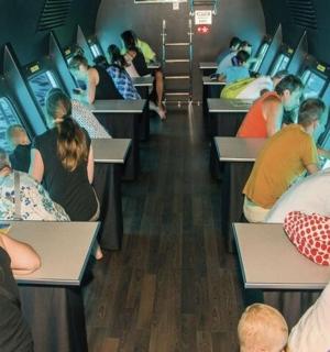 a group of people sitting in a train