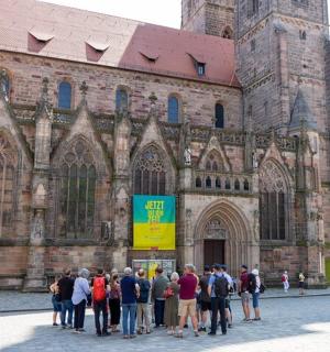 a group of people standing in front of a cathedral