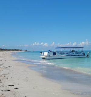 a boat in the water on a beach