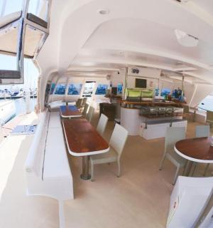a dining room and kitchen inside of a boat