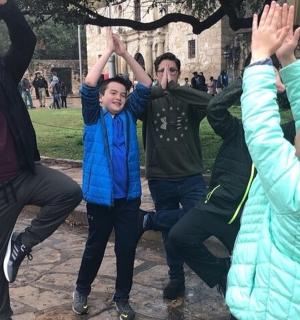 a group of people jumping up in the air