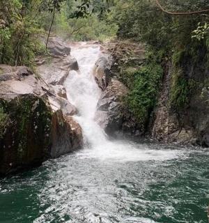 a waterfall on the side of a river