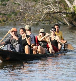 a group of people in a boat on a river