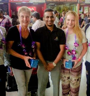 a group of people posing for a picture at an airport