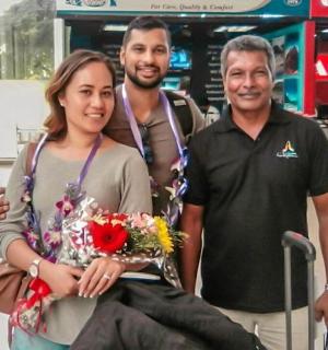 a woman sitting in a wheelchair with two men