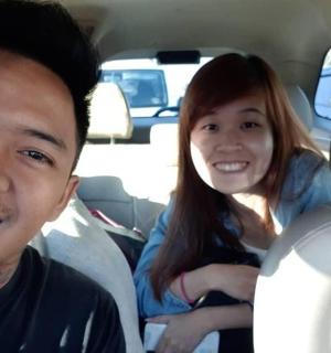 a man and a woman sitting in a car