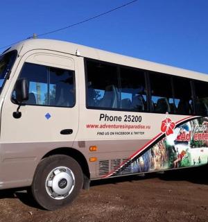 a white bus with an advertisement on the side of it