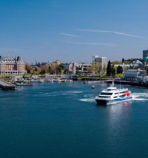 a boat in a river with a city in the background