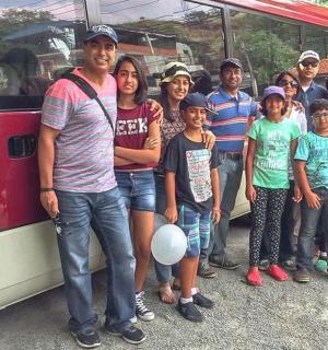 a group of people standing in front of a bus