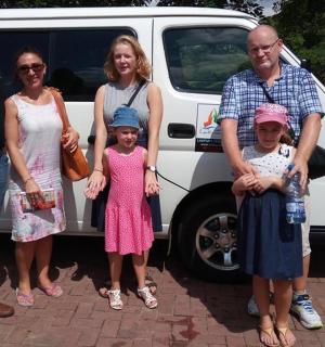 a group of people standing in front of a van