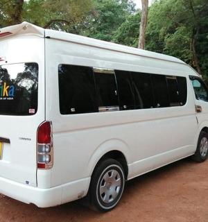 a white van parked on a dirt road