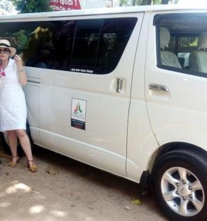 a group of people standing next to a van