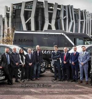 a group of people standing in front of a bus