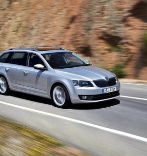 a silver car is driving down a road