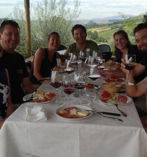 a group of people sitting at a table eating food