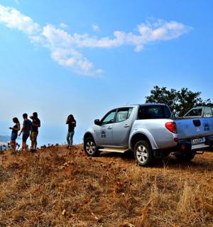 a group of people standing on top of a hill