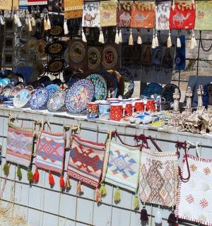 a counter with a lot of vases and other items