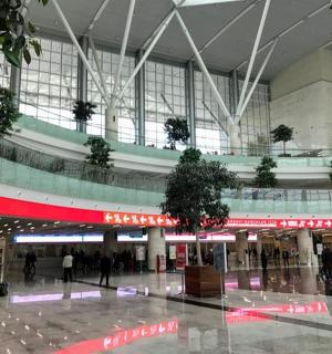 a large airport with people walking around a mall