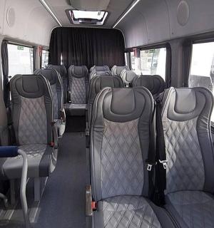 the inside of a bus with empty seats