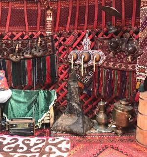 a room with a red wall with various items on it