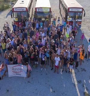 a large group of people standing in front of buses