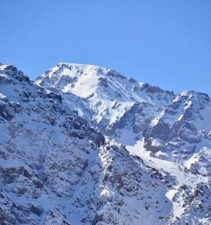 a snow covered mountain with a blue sky