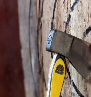 a knife sticking out of the side of a wooden wall