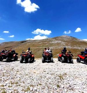 a group of people riding atvs on a rocky hill