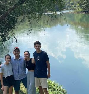 a group of people standing in front of a river