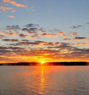 a sunset over a large body of water