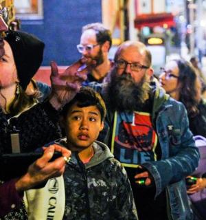 a group of people standing on a city street